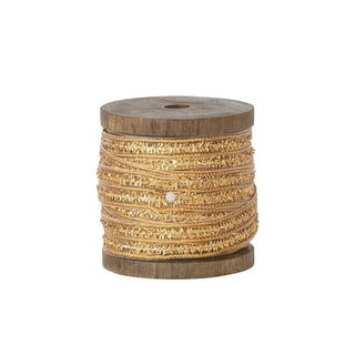 Wooden spool with gold thread on a white background