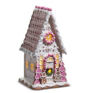 Decorative gingerbread house with lights on a white background