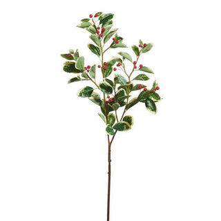 Artificial holly branch with green leaves and red berries on a white background