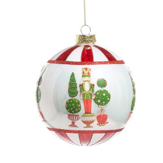 Decorative Christmas ball ornament with a nutcracker and trees design on a white background