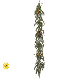 Long artificial Christmas garland with pinecones on a white background