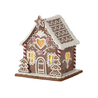 Decorative gingerbread house with icing details on a white background