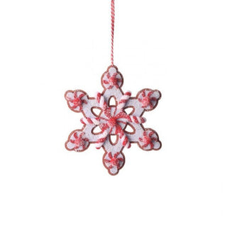 Decorative snowflake ornament with red and white design on a white background