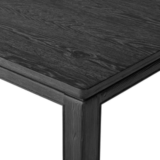 Detailed view of the Oman Dining Table's corner, showcasing its solid construction and subtle relief detail.