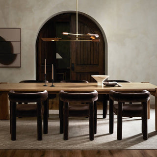 A stylish dining room with the Marcia Dining Table, showcasing a minimalist design with Brazilian influences.