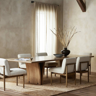 A modern dining room setup with the Marcon Dining Table, styled with warm tones and minimalist decor.