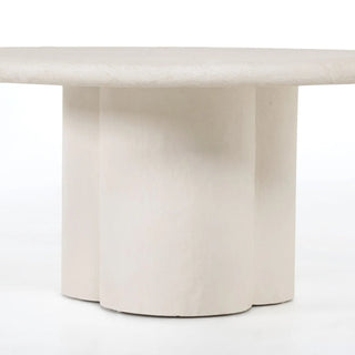 Straight-on view of the Grano Dining Table, showcasing its voluminous base and smooth concrete finish.