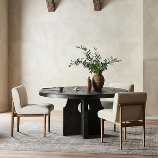 A stylish dining room setup featuring the black Allandale Dining Table, paired with neutral decor and soft lighting.