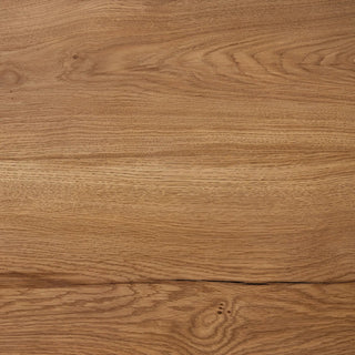 A close-up view of the Marcia Dining Table's reclaimed oak surface, highlighting its natural wood grain.