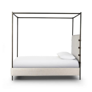 Side profile of a queen-size canopy bed with boucle upholstery and a metal frame, blending modern and classic design.