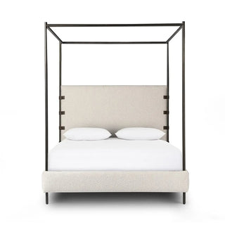 Front view of a modern queen canopy bed with boucle upholstery and a sleek metal frame for a sophisticated bedroom look.