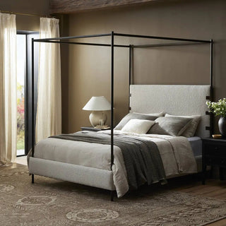 Queen-size canopy bed styled in a modern bedroom with neutral tones, textured linens, and elegant decor.