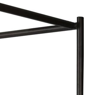 Close-up of the canopy bed’s sleek metal frame, highlighting its durable construction and clean design.