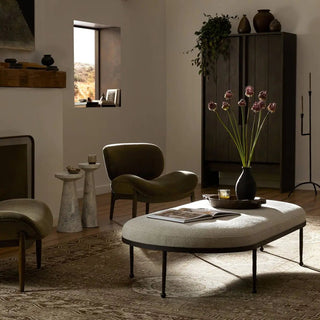 A hammered bronze iron cocktail ottoman styled in a cozy living space with modern decor and natural light.