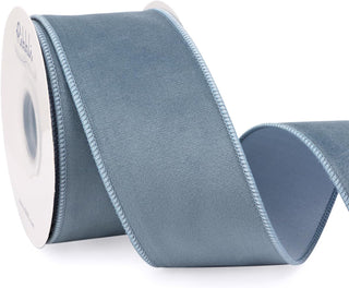 Roll of blue ribbon with a white label on a white background