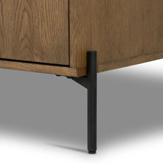 Zoomed-in view of the black metal legs of the amber oak veneer sideboard, showing their sturdy construction.