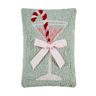 Decorative pillow with a martini glass and candy cane design on a light green background