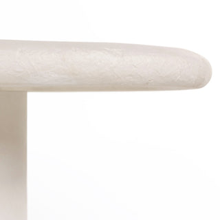 A zoomed-in view of the Grano Dining Table’s surface, showcasing its white concrete texture and natural imperfections.