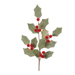 Artificial holly branch with red berries on a white background