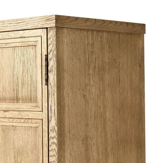 Detailed view of the worn oak cabinet's metal door knobs and panel design.