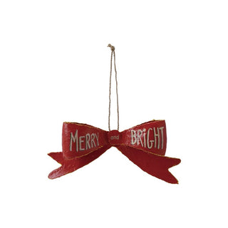 Red bow-shaped ornament with 'Merry and Bright' text on a white background
