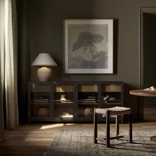 Black drifted oak sideboard styled in a modern living space with decorative accents and warm lighting.