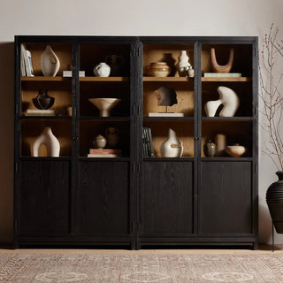 Styled setting of the wide oak cabinet, displaying decorative pieces on its shelves.