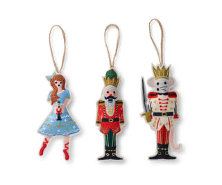 Set of three decorative ornaments resembling characters from a fairy tale on a white background