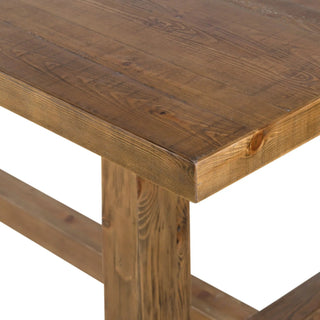 Close-up shot of a wooden dining table’s top surface, showcasing its natural wood grain and texture.