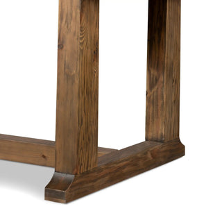 Detailed corner view of a rustic pine wood dining table, highlighting wood grain and craftsmanship.