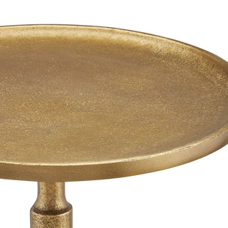 Close-up of the smooth, textured brass tabletop with a refined golden finish for a timeless appeal.