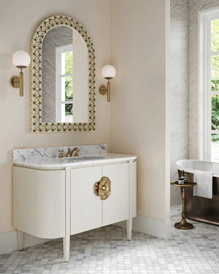 Brass accent table styled in a high-end bathroom with a freestanding tub and luxury vanity – the perfect touch of elegance.