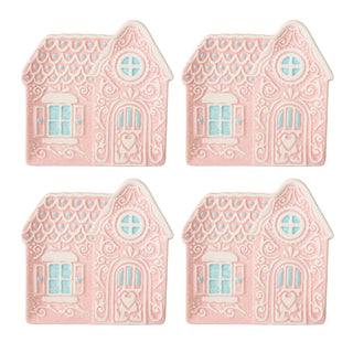 Four pink house-shaped cookies with decorative elements on a white background
