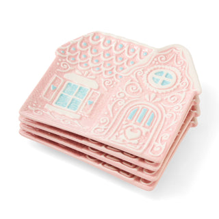 Stack of pink textured coasters with house design on a white background