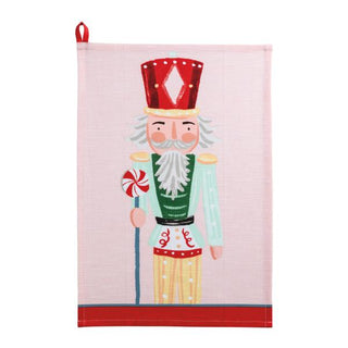 Tea towel with a nutcracker design on a pink background