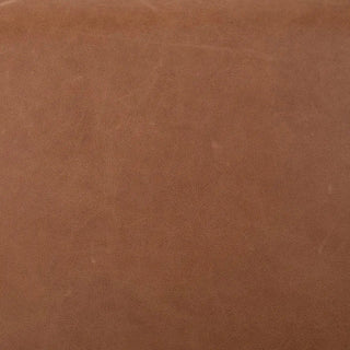 Close-up of premium top-grain leather upholstery in a warm caramel tone, showcasing its smooth texture and natural grain.