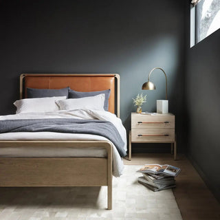 Queen-size oak veneer bed with a top-grain leather headboard, styled in a modern bedroom with soft, neutral bedding.