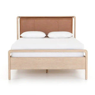 Front view of a modern queen-size bed crafted from oak veneer with a luxurious top-grain leather headboard.