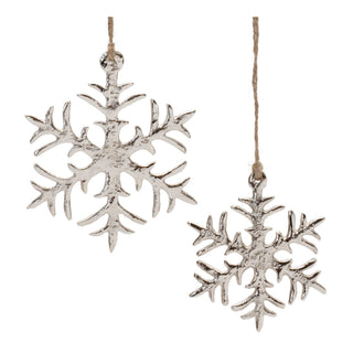 Two silver snowflake ornaments hanging against a white background