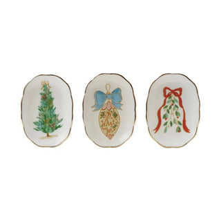 Three decorative plates with Christmas-themed designs on a white background
