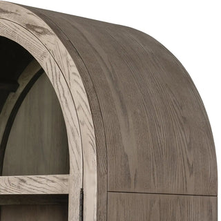 Close-up of the cabinet’s arched top with layered wood detailing.