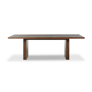 A side view of the Torrington Dining Table, emphasizing its bold structure and waterfall-style leg design.