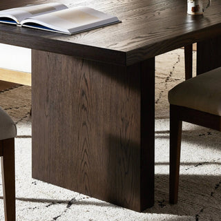 A modern dining room featuring the Torrington Dining Table, styled with natural lighting and elegant decor.