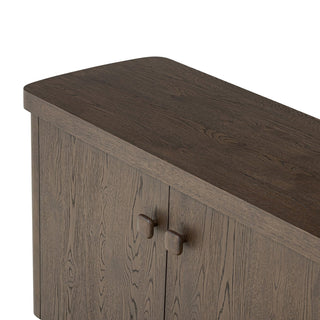 Close-up of the solid wood knobs on the rustic brown oak sideboard, adding a touch of natural elegance.