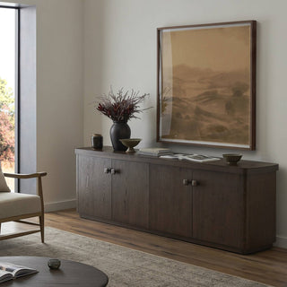 Rustic brown oak sideboard styled in a modern living space with decorative accents and artwork.