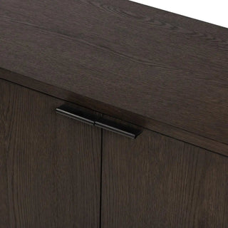 Close-up of the handle design on a modern black oak sideboard, featuring a matte black finish.