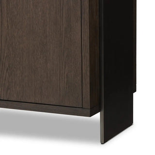 Close-up of the metal leg detail on a modern black oak sideboard, showcasing its sturdy construction.