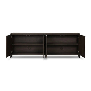 Open storage compartments of a modern black oak sideboard, revealing spacious shelving.