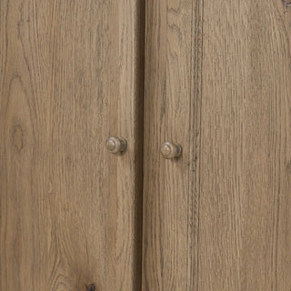 Close-up of cabinet doors with rustic wooden knobs.