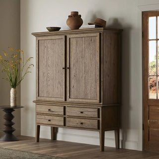 Worn oak cabinet styled in a cozy living space with neutral decor.